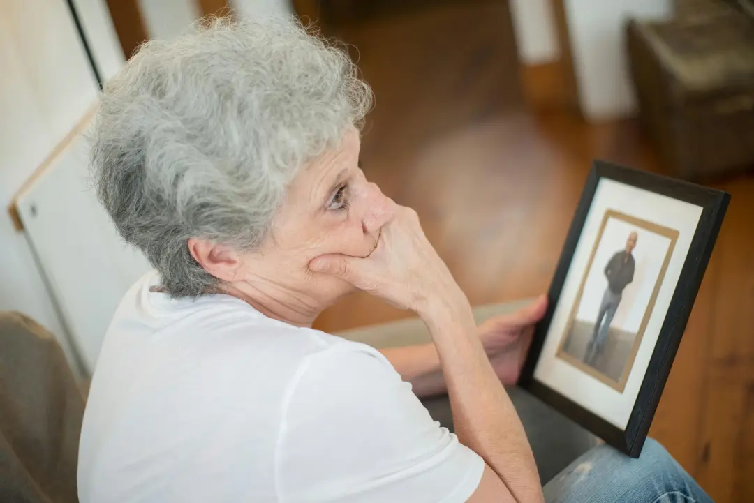 Elderly woman remembering loved ones